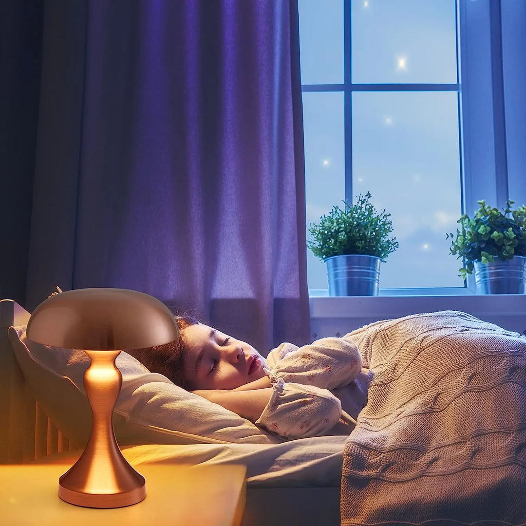 Child sleeping peacefully beside the warm amber glow of a Vespera Luxe Table Lamp