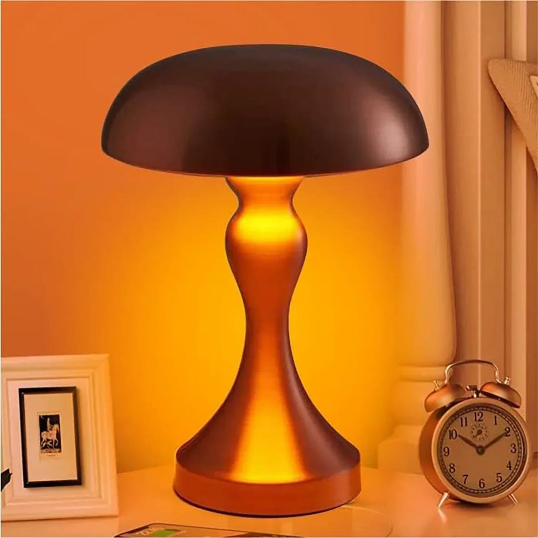 Vespera Luxe Table Lamp glowing warmly on a bedside table next to a vintage clock