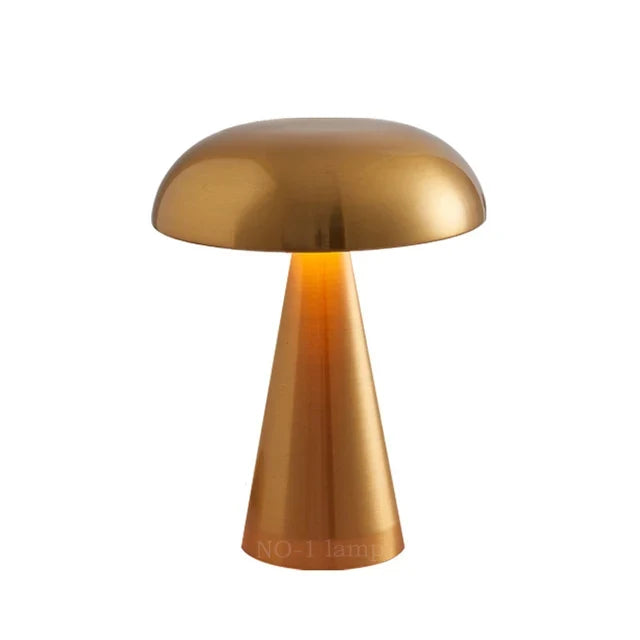 Studio shot of the gold Vespera Luxe Table Lamp showcasing its unique silhouette