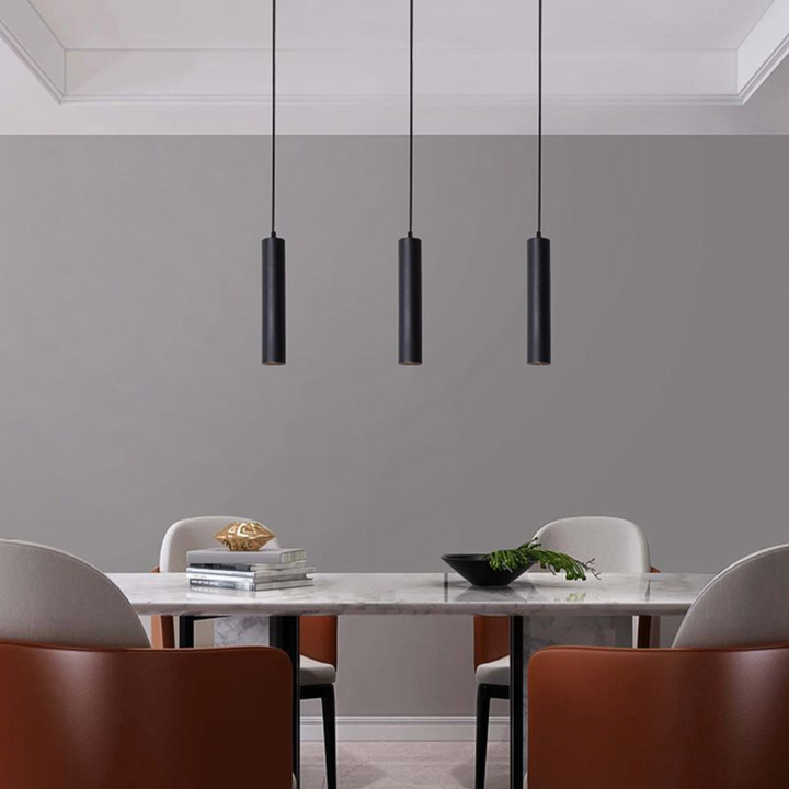 Designer pendant lamp casting warm illumination, ideal for modern dining room decor.
