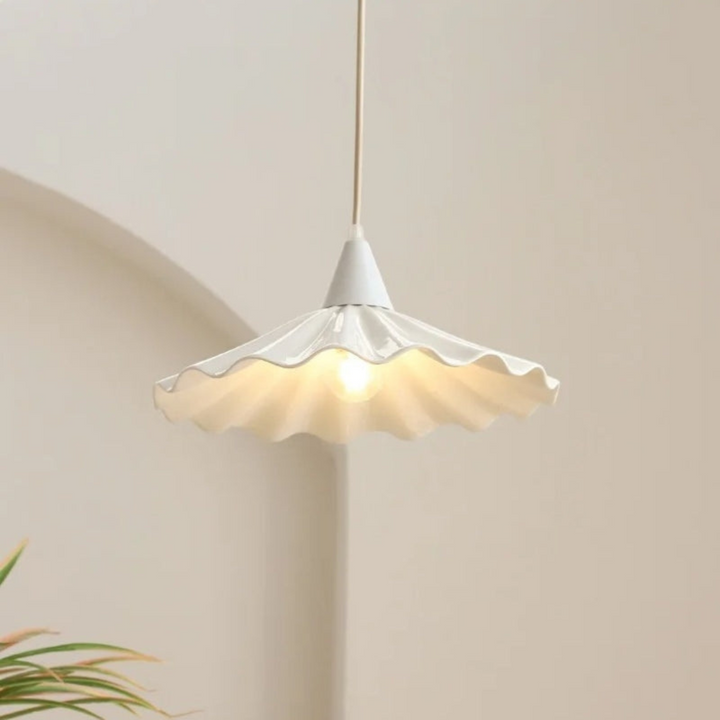 Illuminated white ceramic pendant lamp showcasing its soft down-light