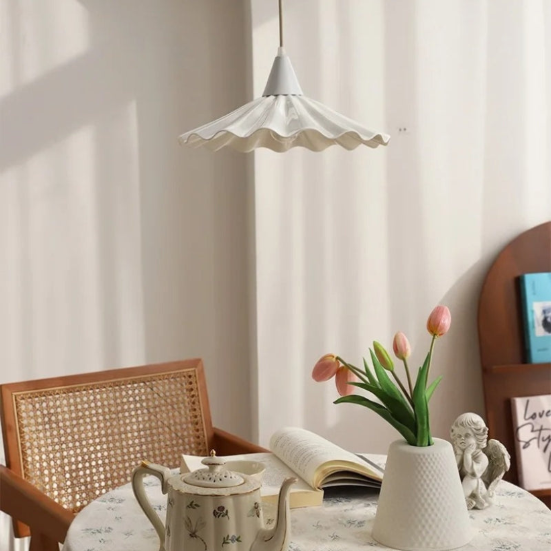 Modern white hanging lamp illuminating a minimalist dining table setup