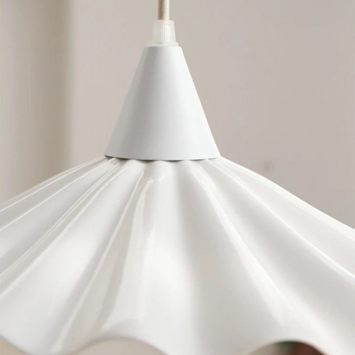 Ceramic ceiling light fixture viewed from below, highlighting its ribbed shade