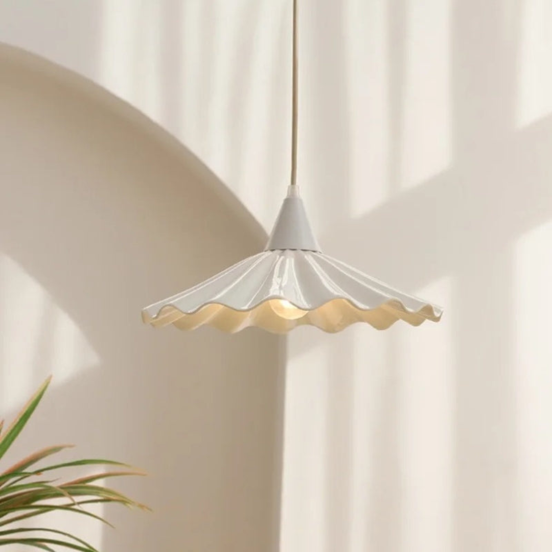 White ceramic ribbed pendant lamp hanging in a modern minimalist interior setting