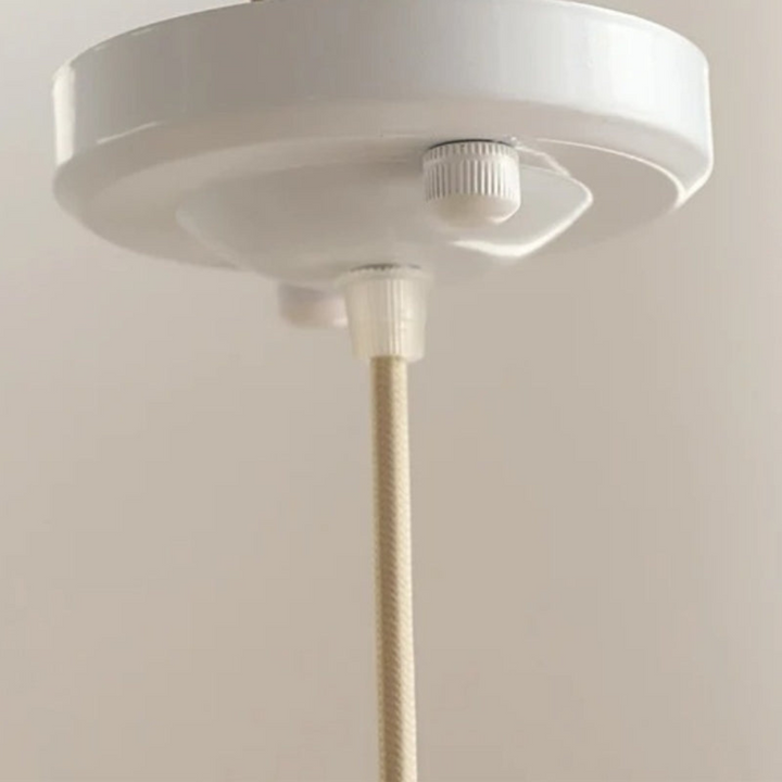 Stylish white pendant lamp illuminating a modern interior dining room