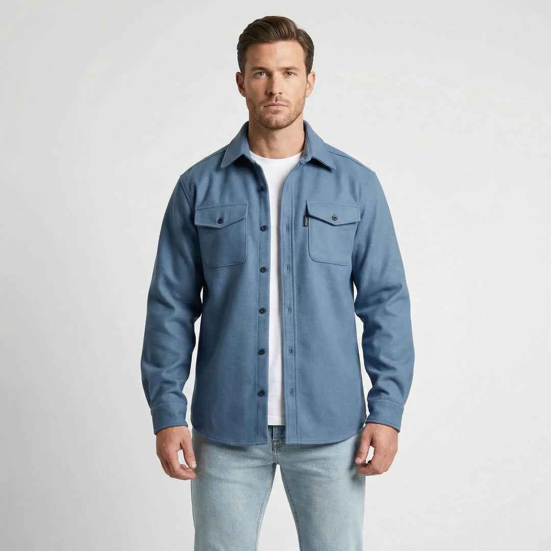 Full-body view of a model wearing a blue overshirt against a white background