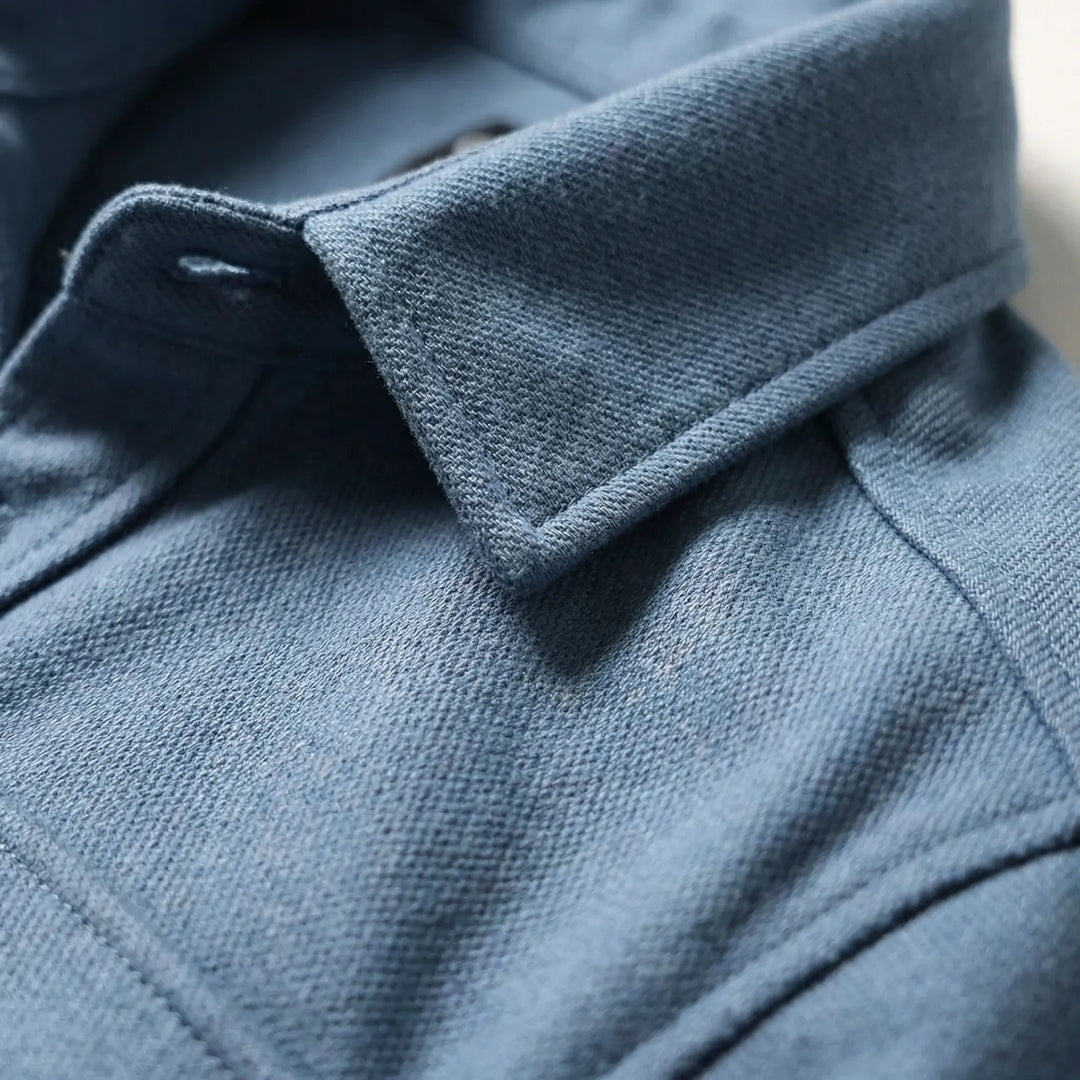 Close-up detail of the collar and textured fabric of the blue overshirt