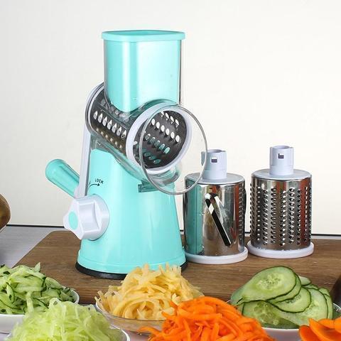 Blue multifunctional vegetable slicer with interchangeable blades on a wooden board