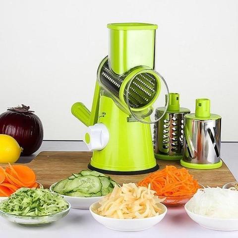 Green vegetable slicer with fresh sliced vegetables displayed around it