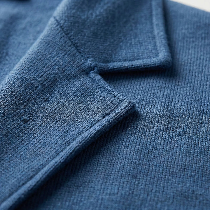 Close-up shot showing the textured fabric and lapel collar of the blazer