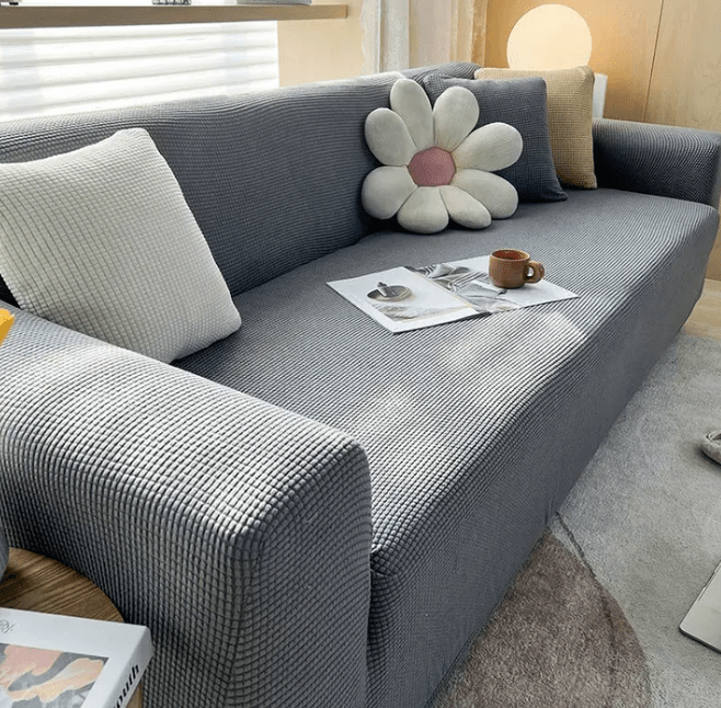 Light grey sofa cover fitted smoothly on a modern living room sofa