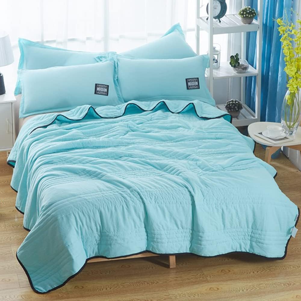 Minimalist bedroom decor featuring the cooling blanket on a white bed