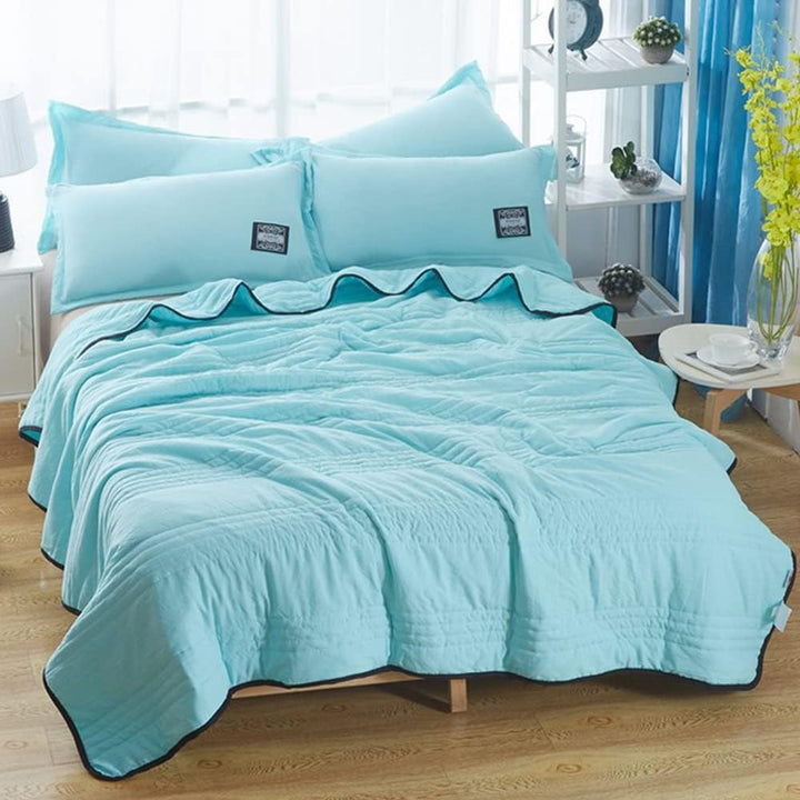 Minimalist bedroom decor featuring the cooling blanket on a white bed