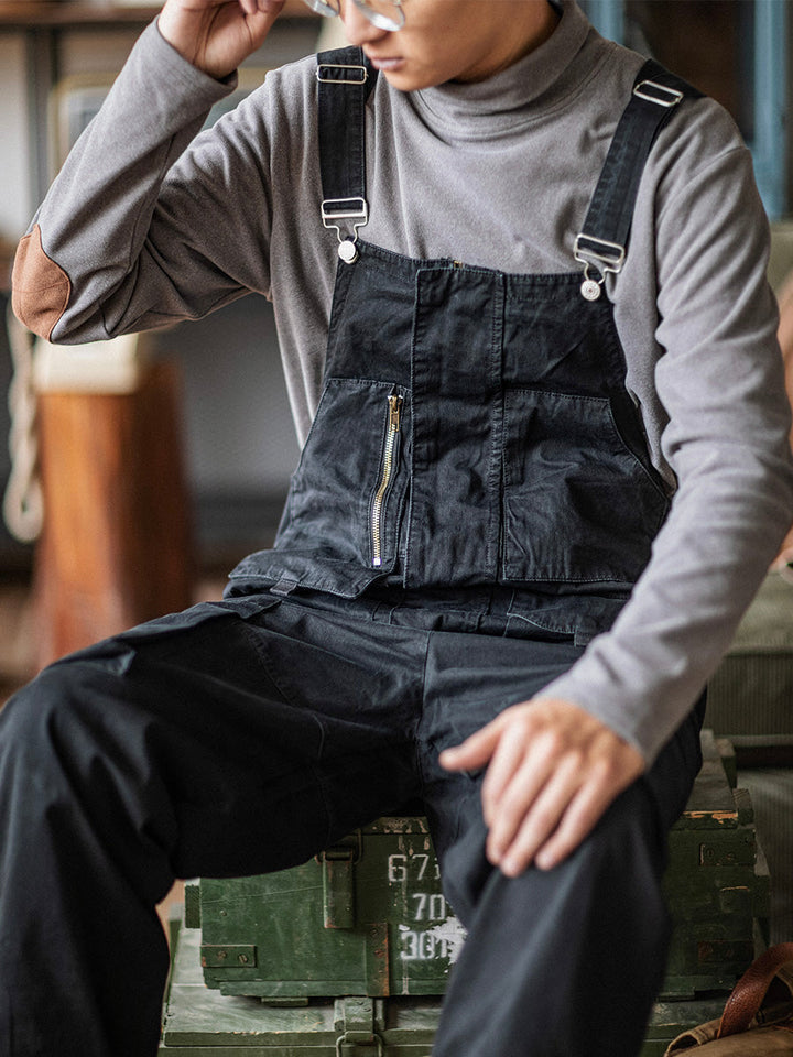 Textured fabric swatch and hemline detail of men's cargo overalls