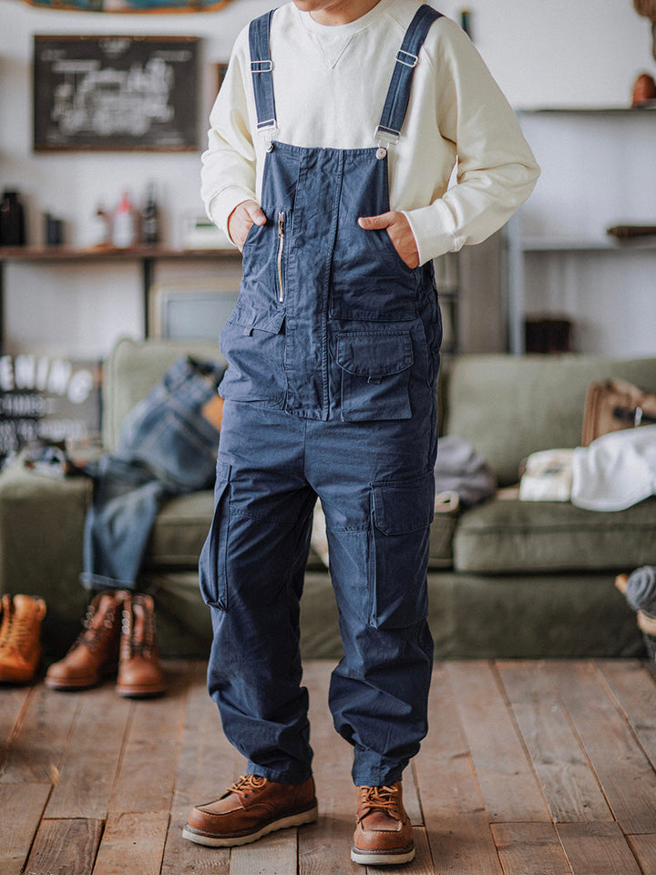 Detailed shot of adjustable waist tabs on men's utility overalls
