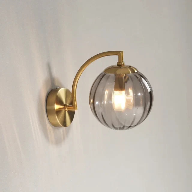 Scandinavian glass LED wall sconce illuminating a modern living room