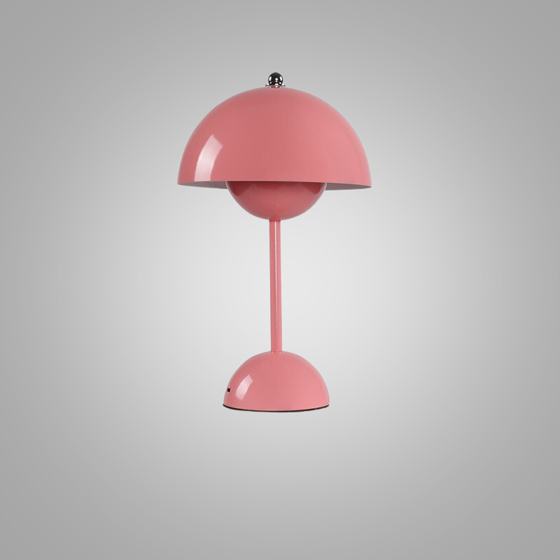 Portable battery-operated table lamp casting warm glow on a wooden surface