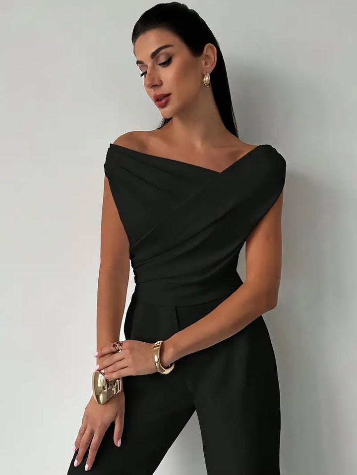 Side profile of the draped shoulder top highlighting its flattering fit