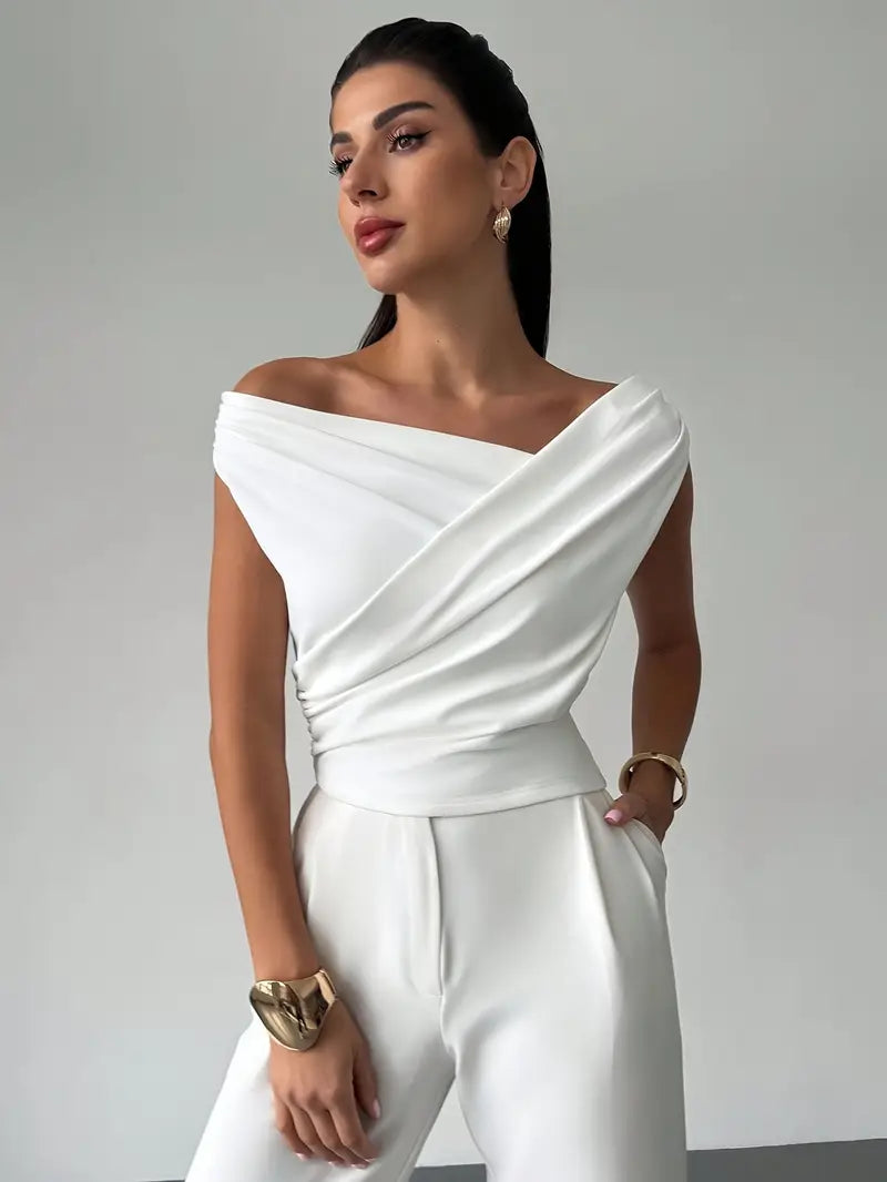 Model wearing white elegant draped shoulder top