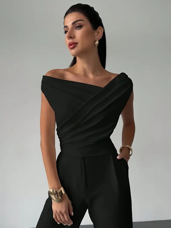 Model wearing black elegant draped shoulder top