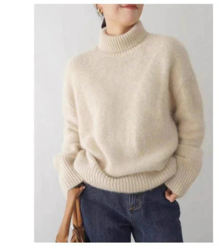 Woman wearing a beige turtleneck sweater with jeans