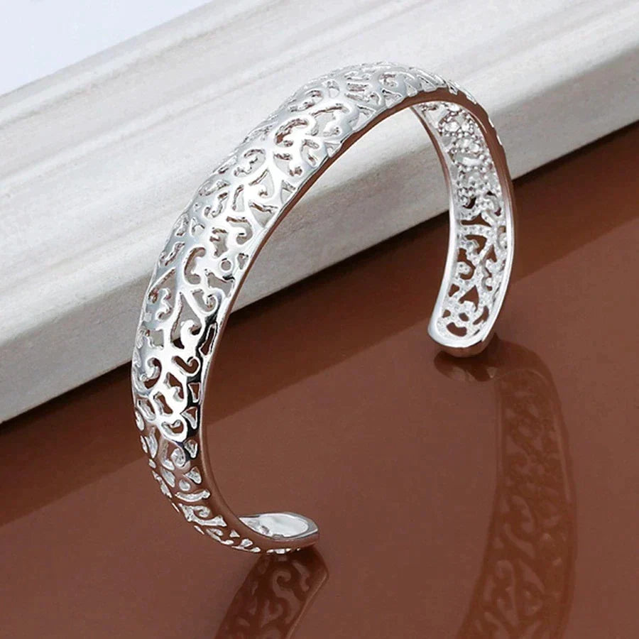 Close-up angled view of the silver openwork cuff bracelet