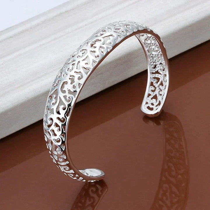 Close-up angled view of the silver openwork cuff bracelet