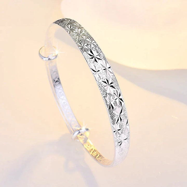 Close-up of sparkling star patterns on a 925 sterling silver adjustable bangle