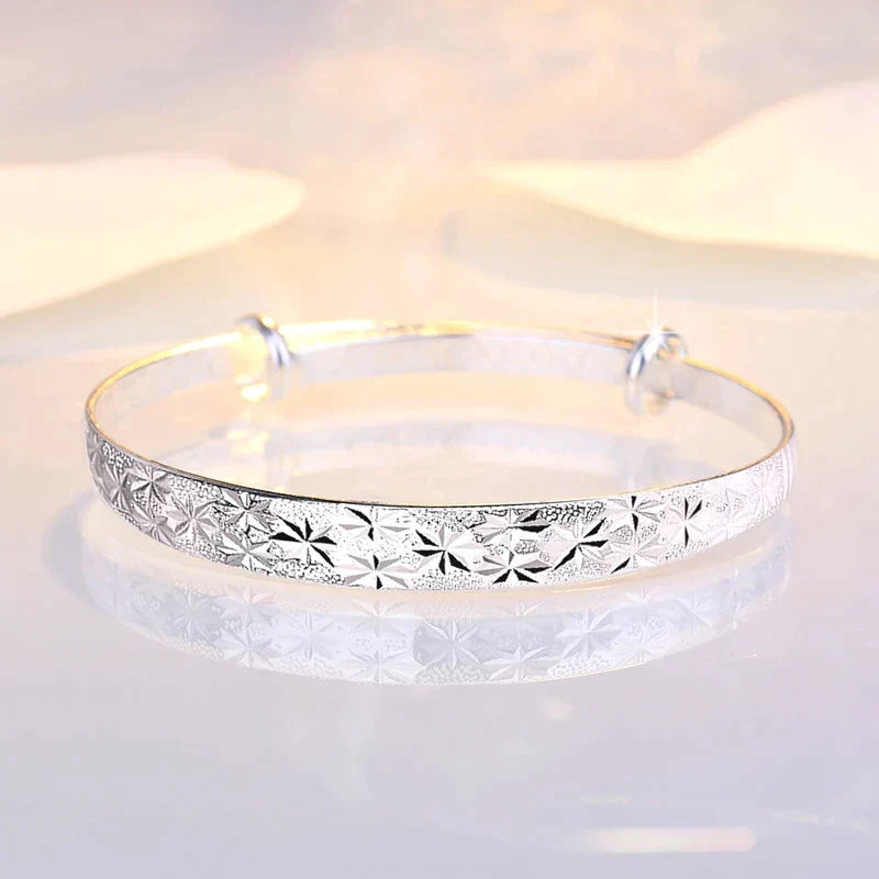 Detailed view of the sliding mechanism on the silver star bangle for custom sizing
