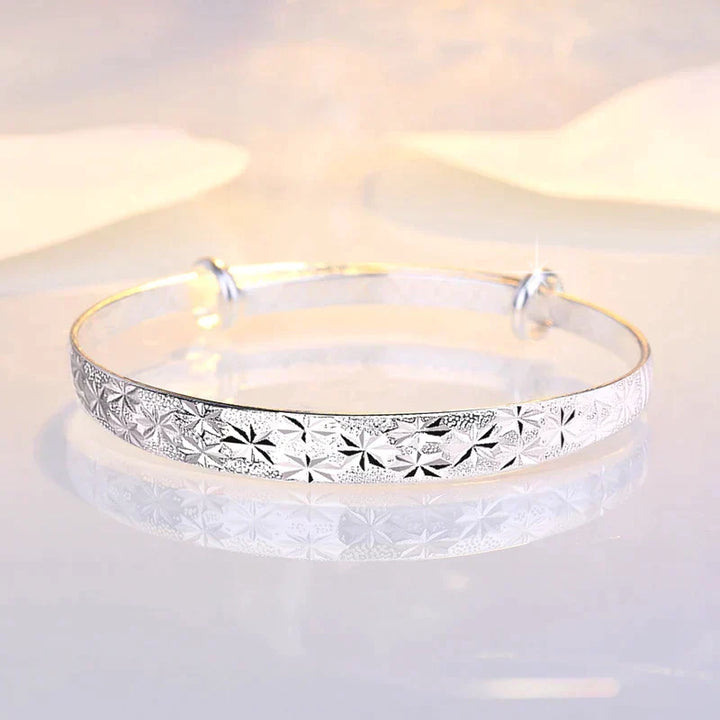 Detailed view of the sliding mechanism on the silver star bangle for custom sizing
