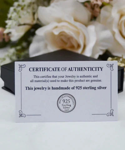 Certificate of authenticity card displayed with the jewelry packaging