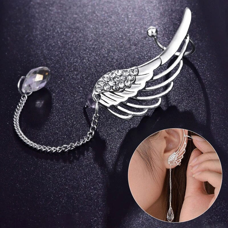 Close up of silver angel wing ear cuff worn on ear