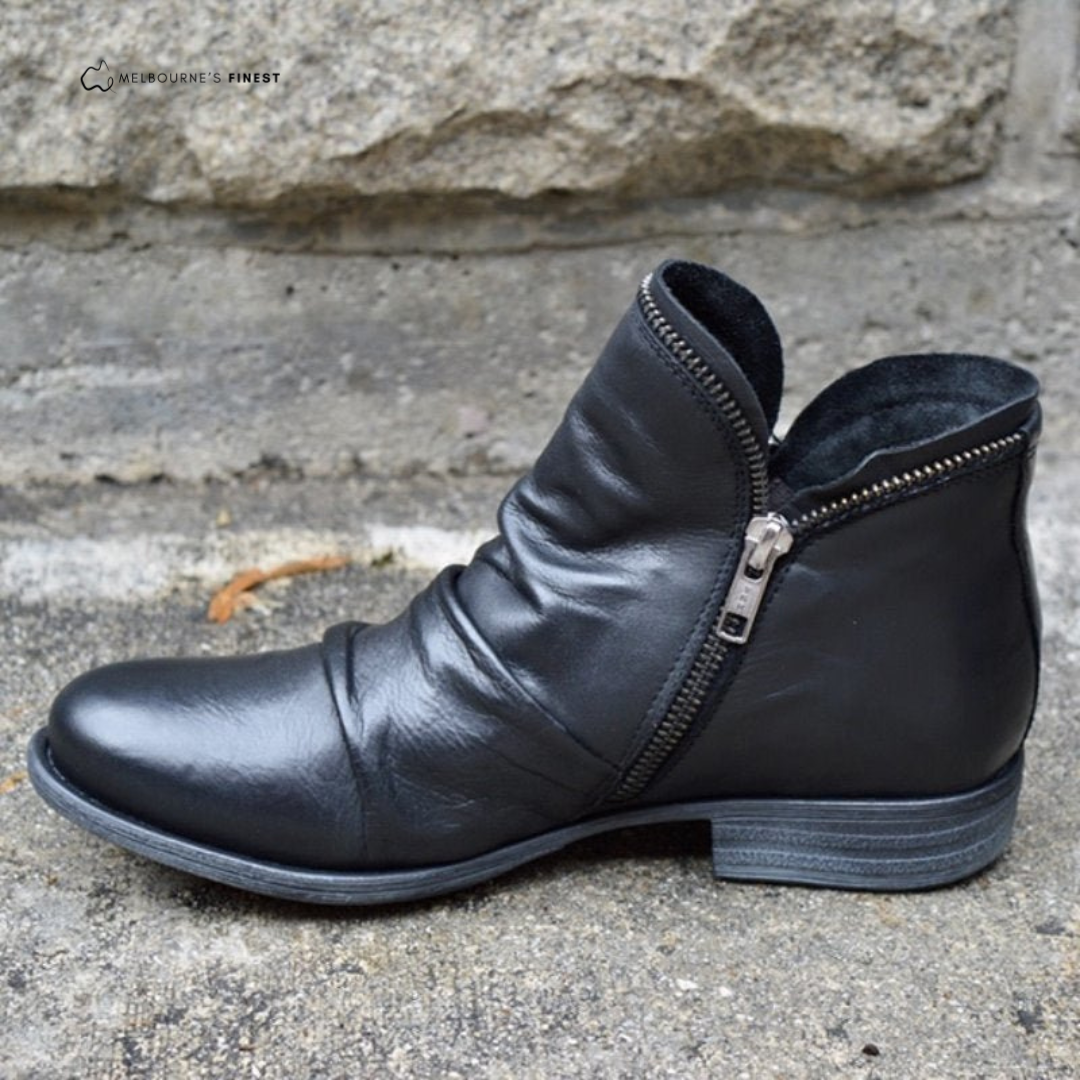 Black orthopedic ankle boot viewed from the side