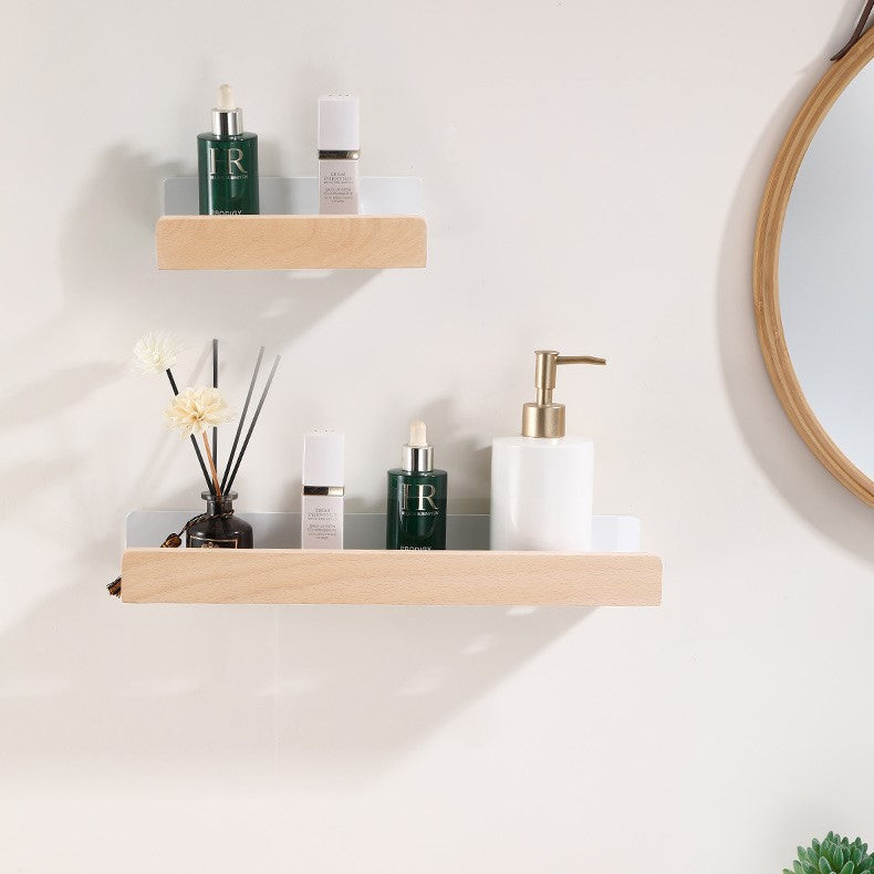 Minimalist wall shower rack with natural wood accent and toiletries displayed on a white wall