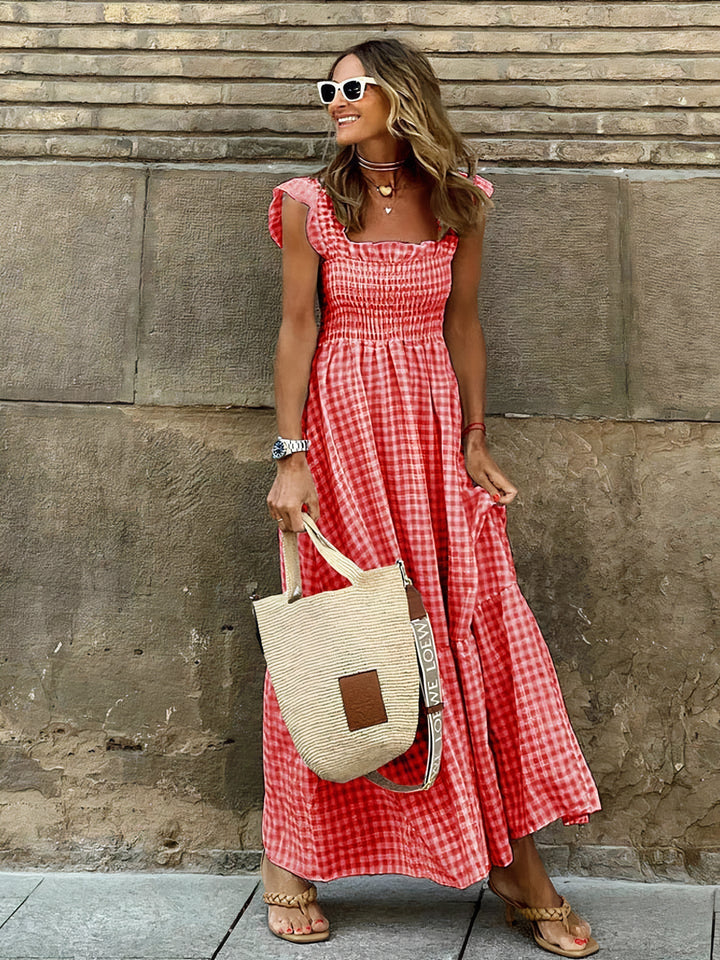 Woman wearing red check maxi dress paired with casual sandals