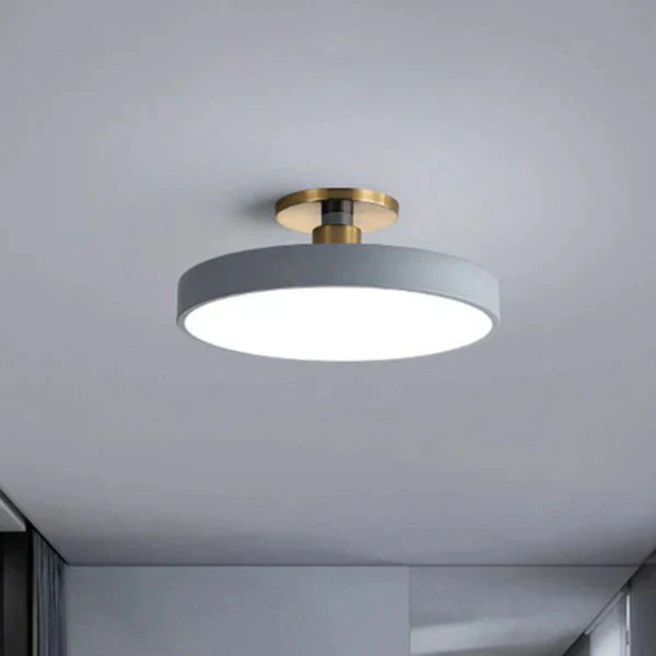 Modern nordic LED ceiling light mounted on white drywall