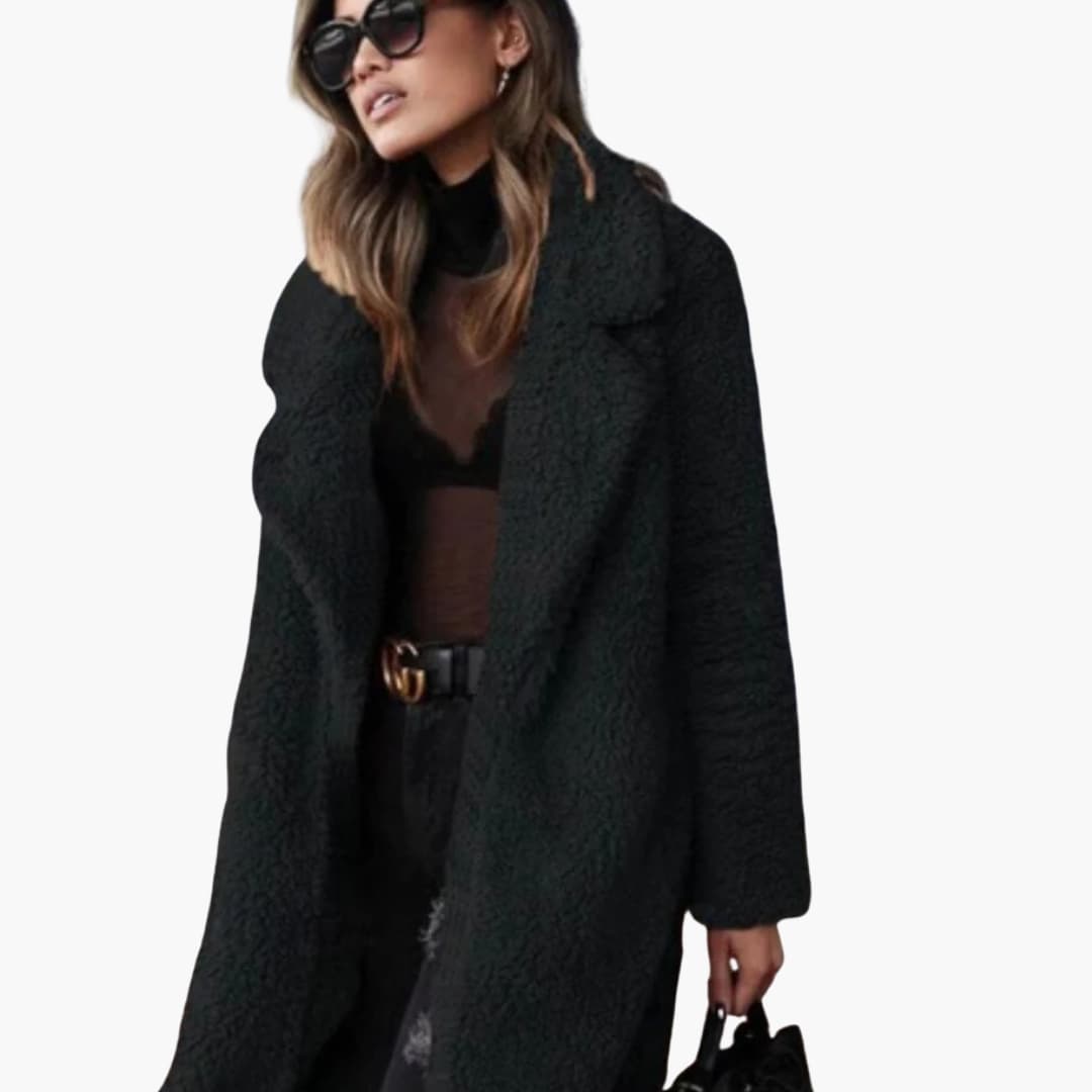 Woman wearing black long teddy coat with sunglasses and handbag