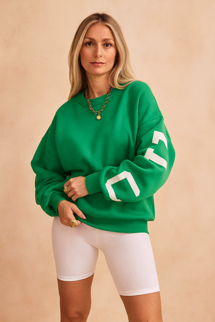 Woman wearing green casual pullover sweater with white shorts