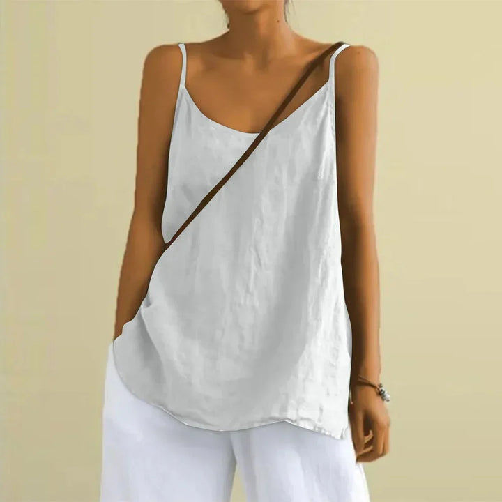 Woman wearing the white sleeveless casual top paired with white trousers