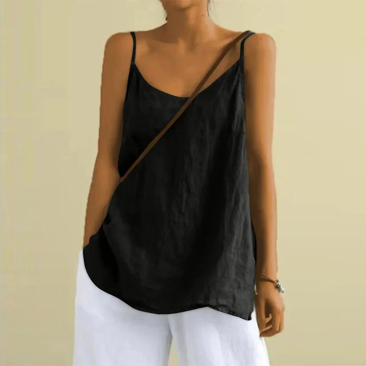 Woman wearing the black sleeveless casual top paired with white trousers