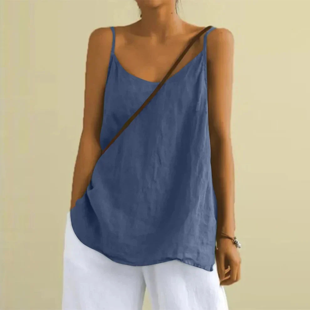 Woman wearing the blue sleeveless casual top paired with white trousers