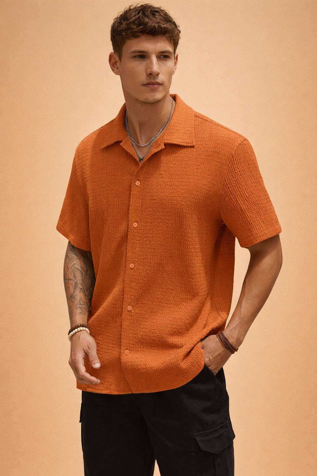 Detailed view of the textured fabric and button placket on the men's short-sleeve shirt.