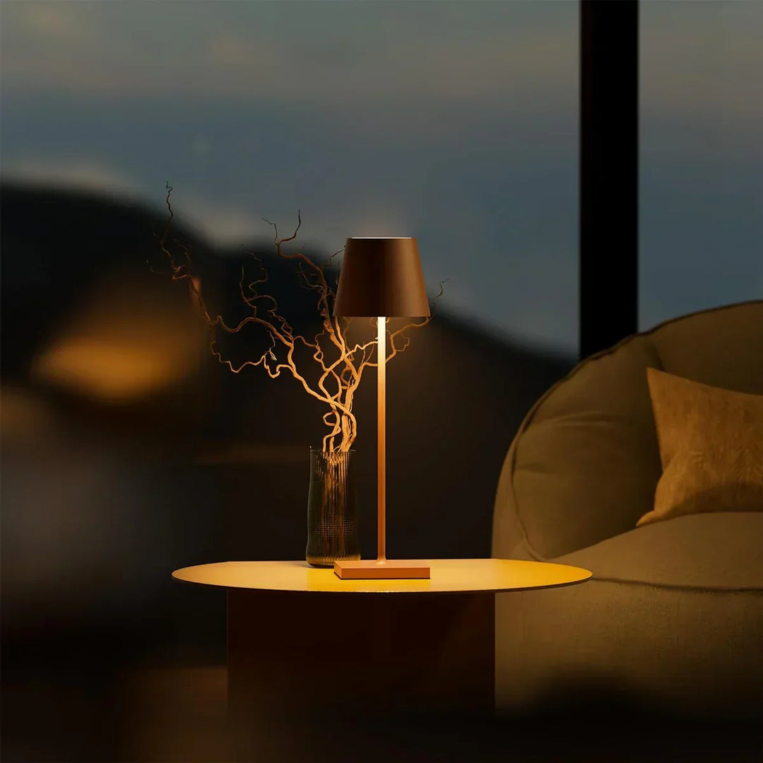 Minimalist LED desk lamp glowing softly in a dim home office