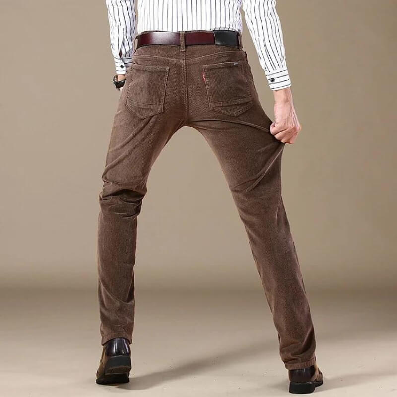 Folded stack of all season mens slim fit trousers in vintage style and textured material