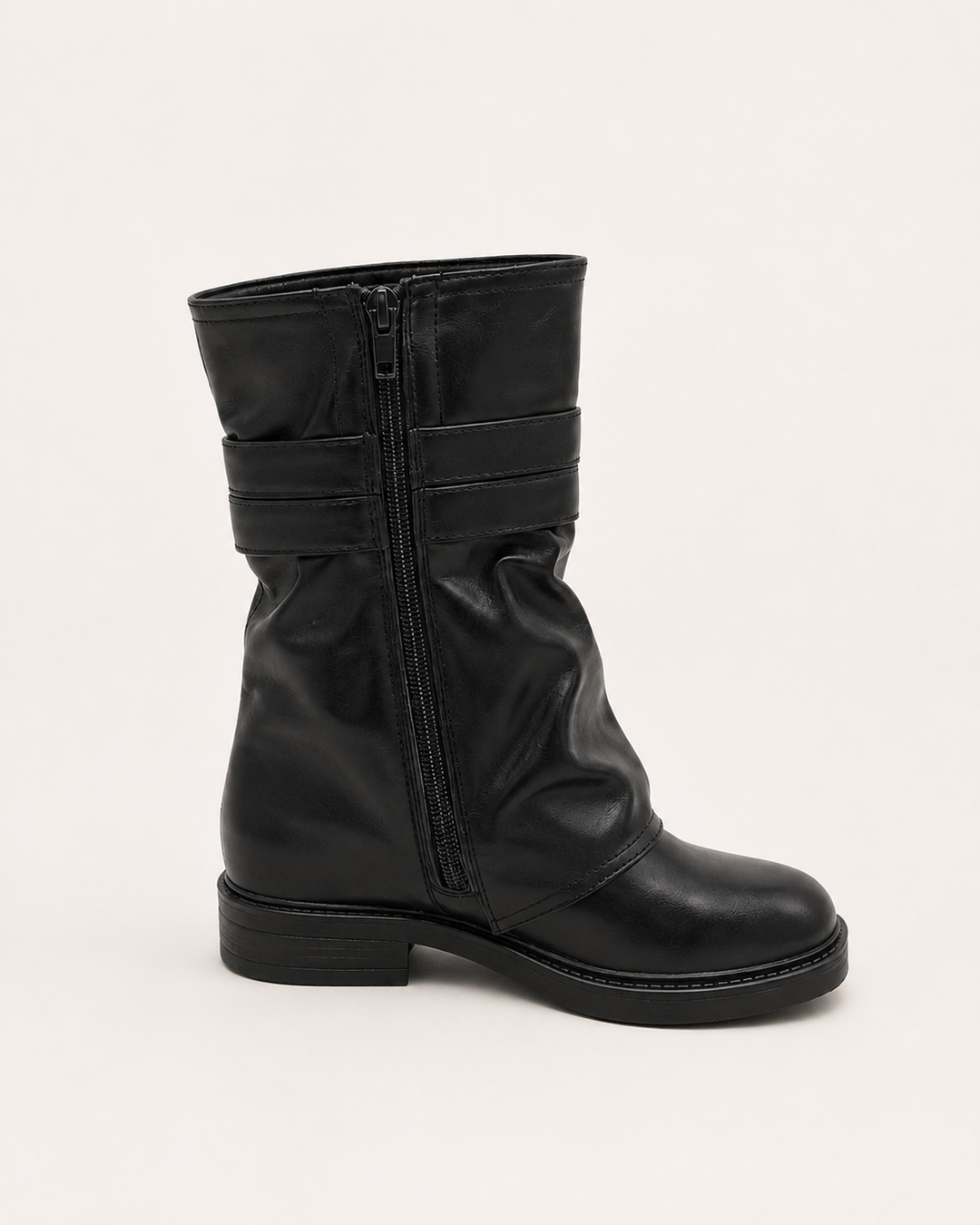 Women's black buckled biker boots featuring low heel and edgy autumn style footwear design.