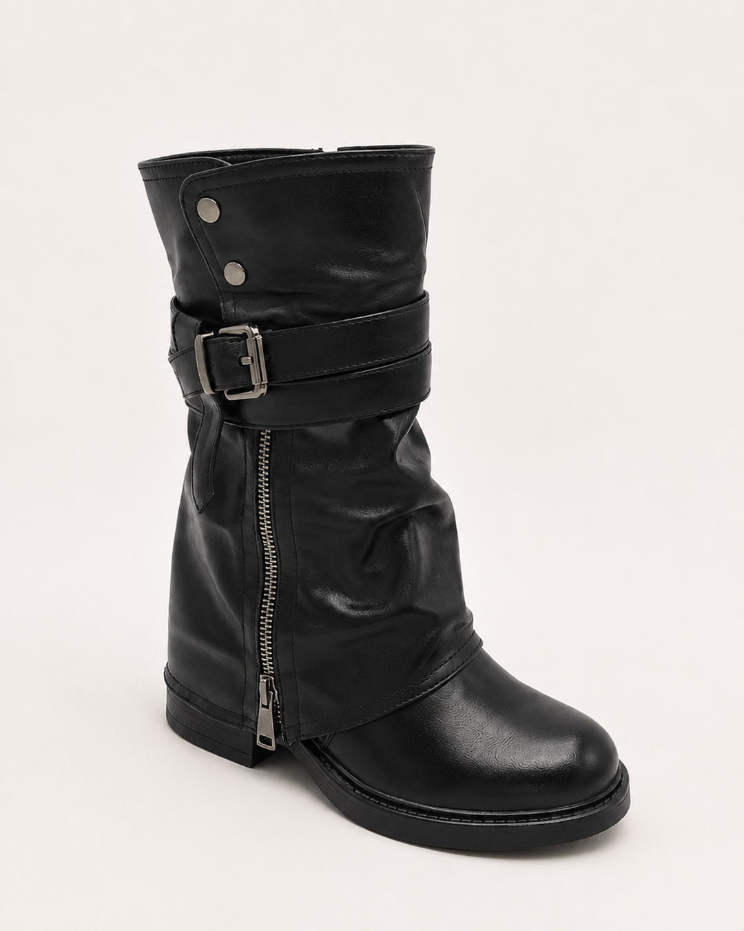 Studio shot of single women's black biker boot with buckle and zip closure