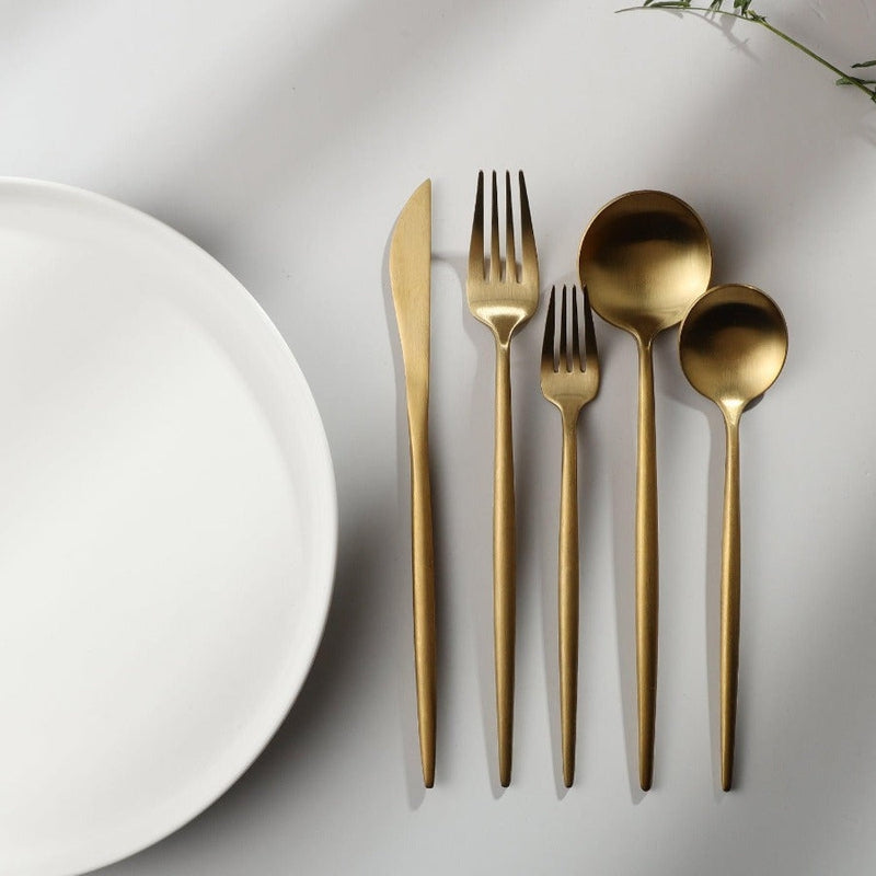 Complete service cutlery set laid out for a formal table setting
