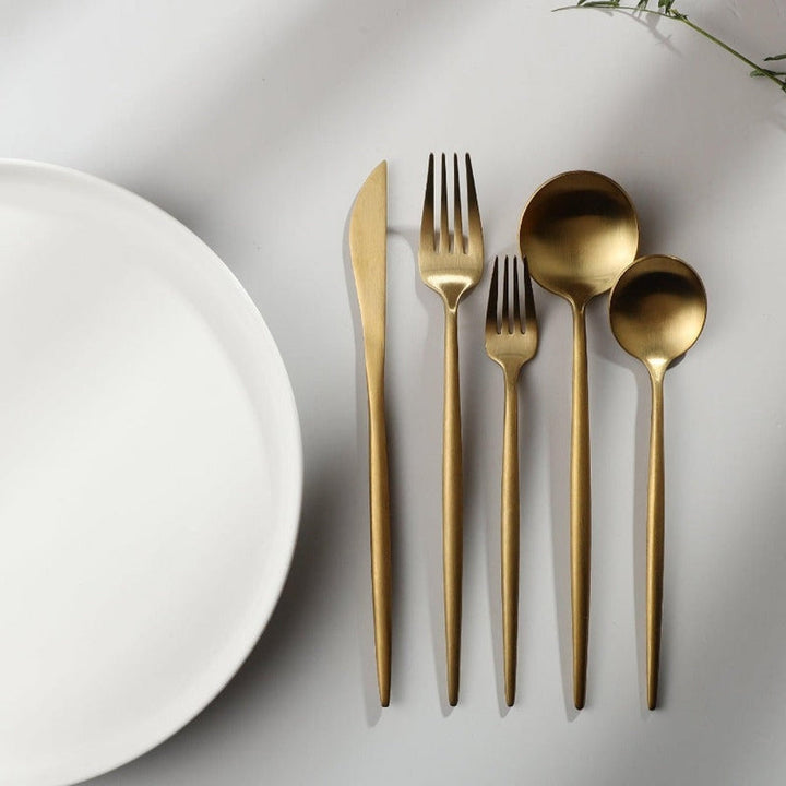 Complete service cutlery set laid out for a formal table setting