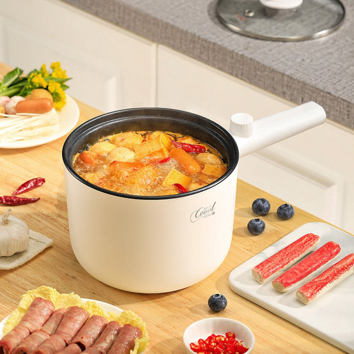 Portable mini hot pot appliance on a kitchen countertop for quick meals