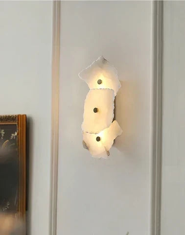 Detailed shot of the metal frame and natural stone in this modern wall light